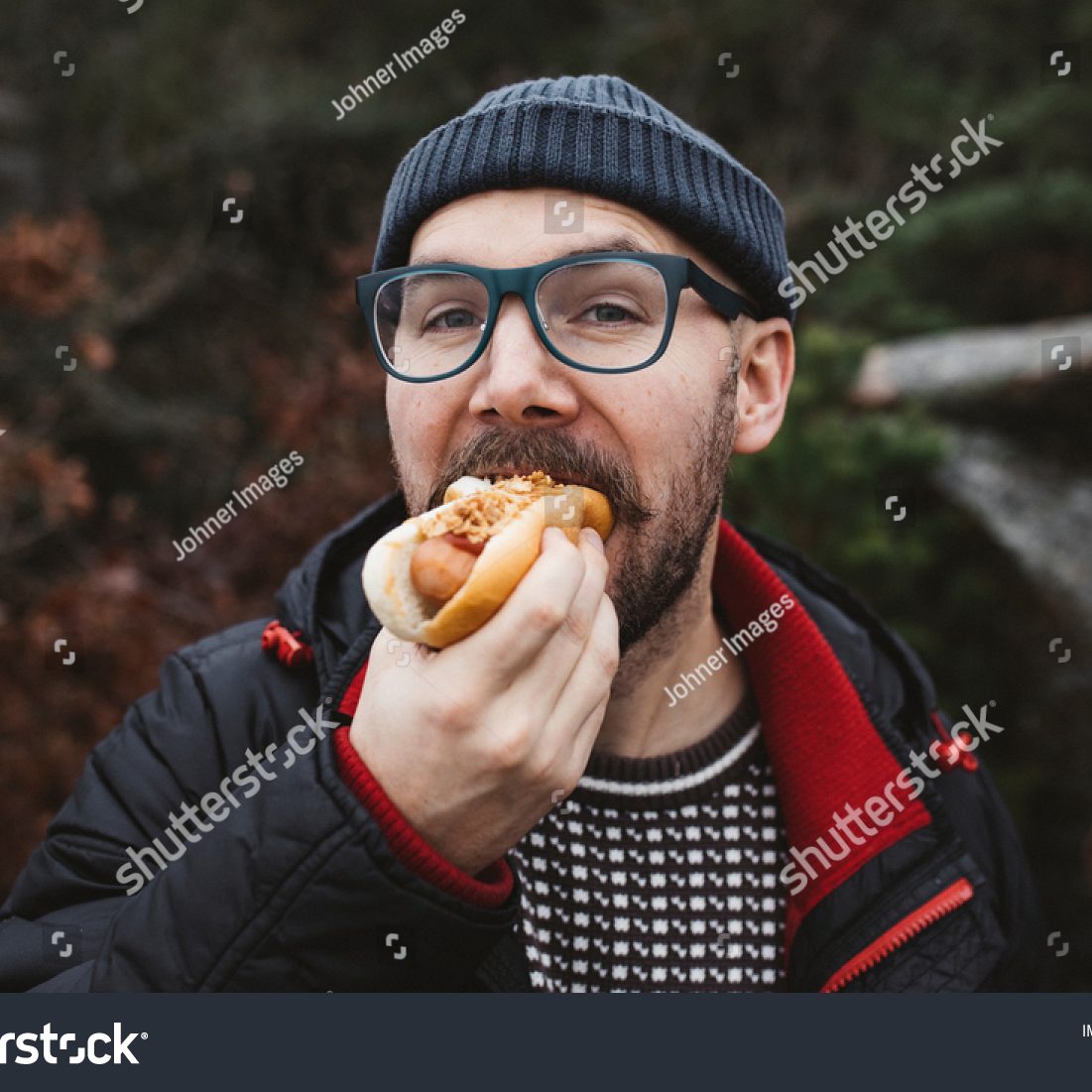 stock-photo-man-eating-delicious-hotdog-alone-1948450588